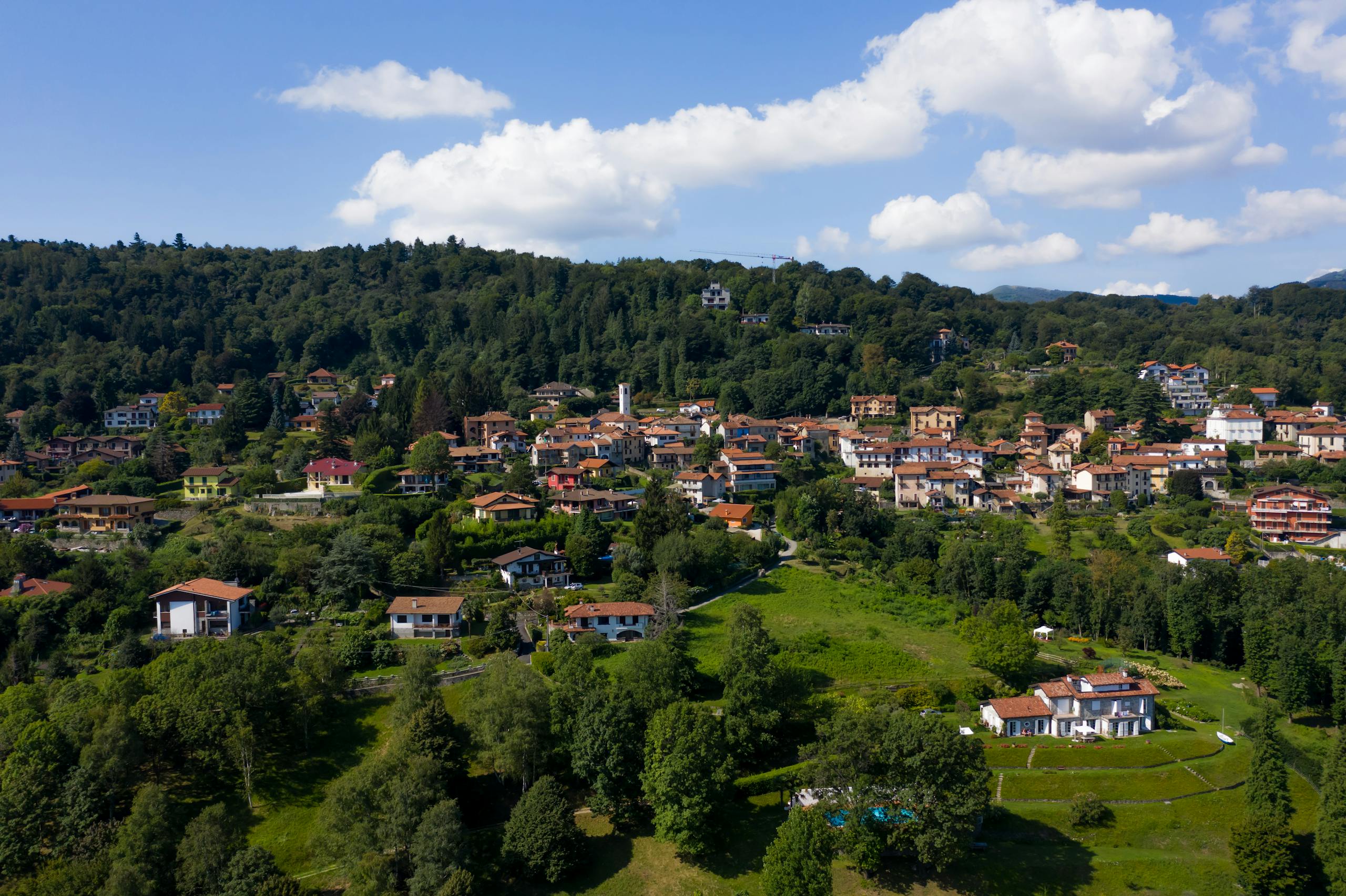 Scenic aerial shot capturing the lush greenery and charming homes of an Italian village.